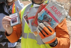 A worker shows the media the first recovered "E.T. the Extra-Terrestrial" cartridge at the old Alamogordo landfill in Alamogordo, New Mexico, April 26, 2014. Documentary filmmakers digging in a New Mexico landfill on Saturday unearthed hundreds of "E.T. the Extra-Terrestrial" cartridges, considered by some the worst video game ever made and blamed for contributing to the downfall of the video game industry in the 1980s.  REUTERS/Mark Wilson   (UNITED STATES - Tags: ENTERTAINMENT SCIENCE TECHNOLOGY SOCIETY)